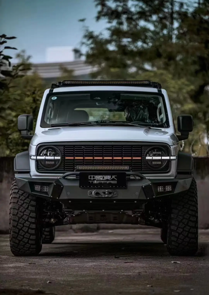 A grey Tank 300 with a top fire front grille "Darkness" and orange daytime running lights illuminated.