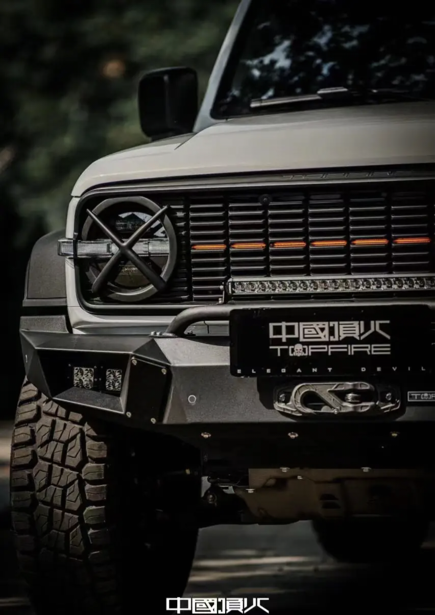 A Tank 300 featuring a top fire front grille "Darkness" with orange daytime running lights illuminated.